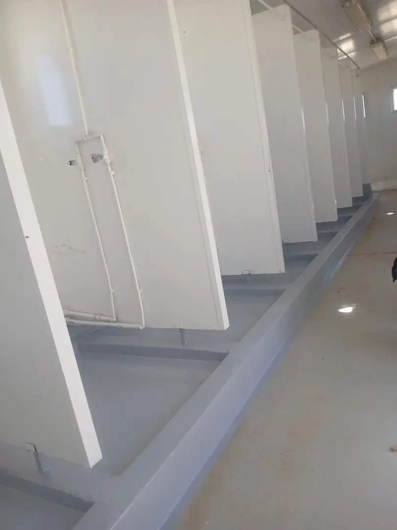 Row of shower cubicles with a new grey coated floor